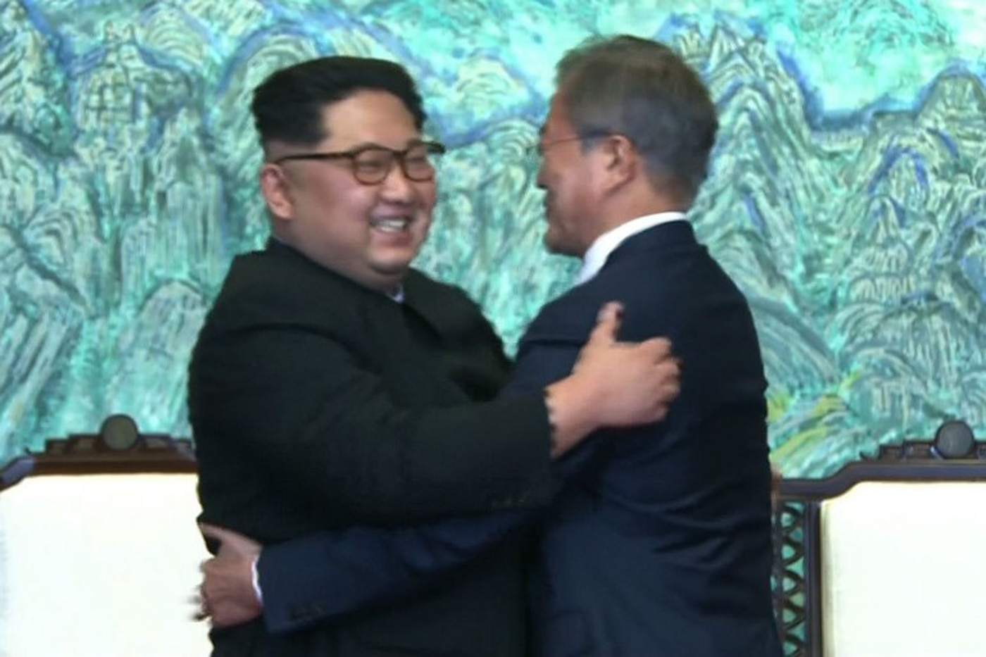 This screen grab from the Korean Broadcasting System (KBS) taken on April 27, 2018 shows North Korea's leader Kim Jong-Un (L) embracing South Korea's President Moon Jae-in (R) near the end of their historic summit at Panmunjom. AFP PHOTO / KOREAN BROADCASTING SYSTEM