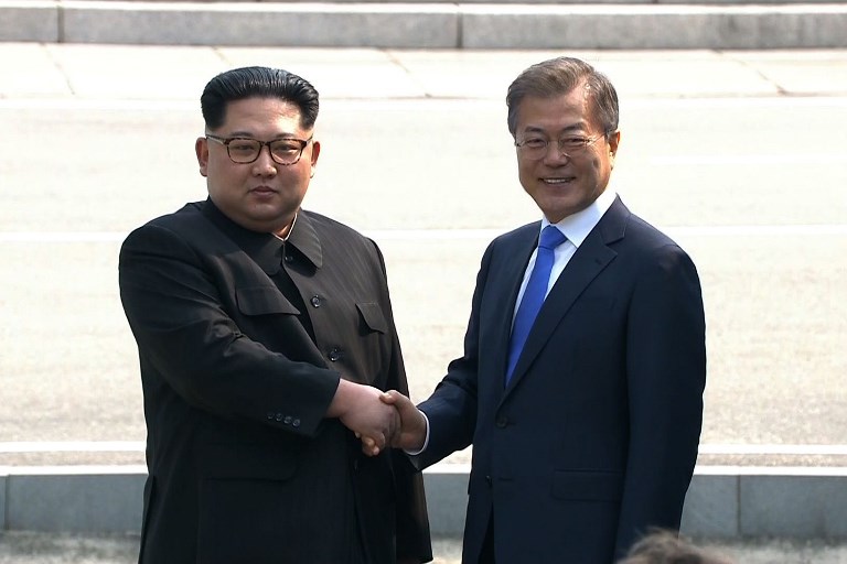 HISTORIC. This screen grab from the Korean Broadcasting System (KBS) taken on April 27, 2018 shows North Korea's leader Kim Jong-Un (L) and South Korea's President Moon Jae-in shaking hands at the Military Demarcation Line that divides their countries at Panmunjeom. AFP PHOTO / KOREAN BROADCASTING SYSTEM (KBS)  