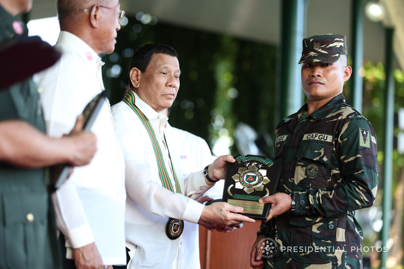 President Rodrigo Duterte confers the CAFGU Active Auxiliary (CAA) of the year 2017 award on CAA Erwin Abogado 