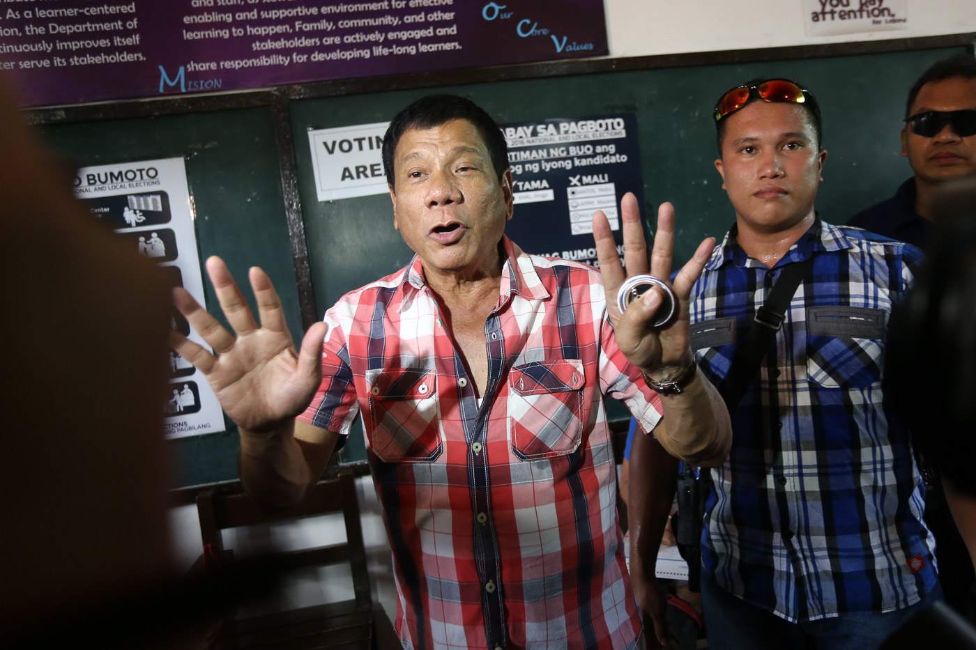Presidential candidate and Davao City Mayor Rodrigo Duterte casts his vote at the Daniel R. Aguinaldo National High School in Matina Aplaya district. Photo by Manman Dejeto/Rappler 