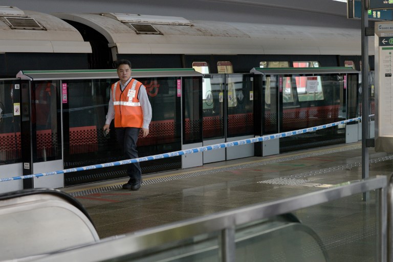 CORDONED OFF. A SMRT staff walks past one of the two trains that collided at a train station in Singapore on November 15, 2017. Toh Ting Wei/AFP 
