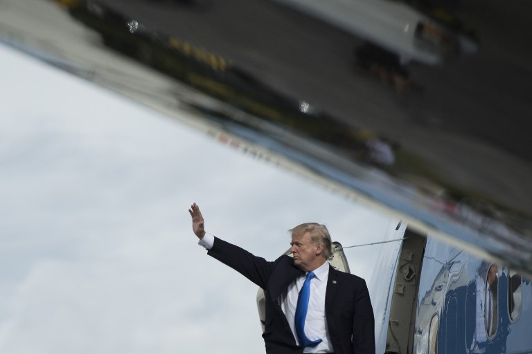 'BYE, ASIA. US President Donald Trump waves as he boards Air Force One after attending the 31st Association of Southeast Asian Nations (ASEAN) Summit in Manila on November 14, 2017. Jim Watson/AFP 