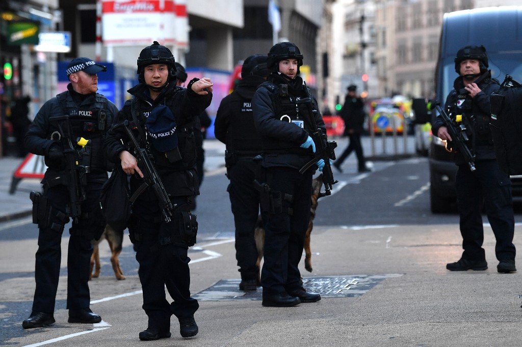 FEAR. Armed police stand guard at Cannon Street station in central London, on November 29, 2019 after reports of shots being fired on London Bridge. Photo by Ben Stansall/AFP 