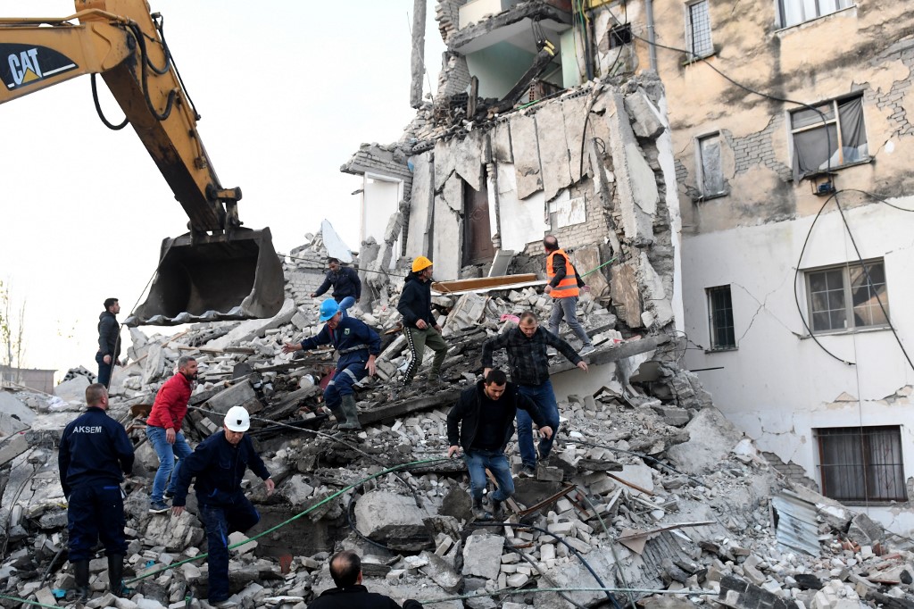 ALBANIA EARTHQUAKE. Emergency workers clear debris at a damaged building in Thumane, 34 kilometres (about 20 miles) northwest of capital Tirana, after an earthquake hit Albania, on November 26, 2019. Photo by Gent Shkullaku/AFP 