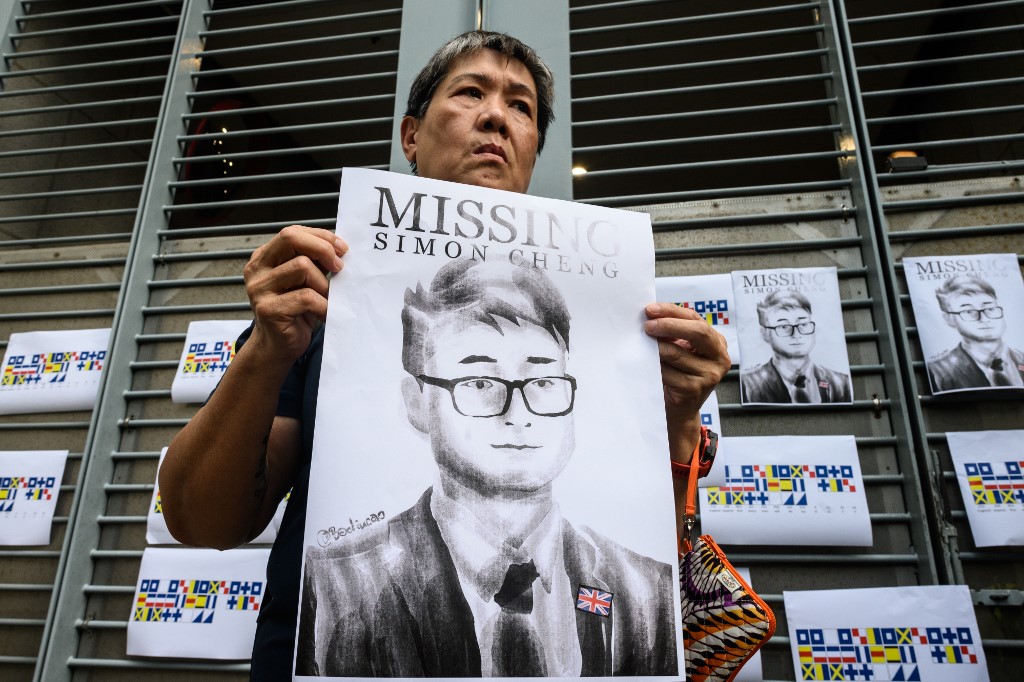 SIMON CHENG. An activist holds an illustration of Simon Cheng during a gathering outside the British Consulate-General building in Hong Kong on August 21, 2019, following reports that the Hong Kong consulate employee had been detained by mainland Chinese authorities on his way back to the city. Photo by Anthony Wallace/AFP 
