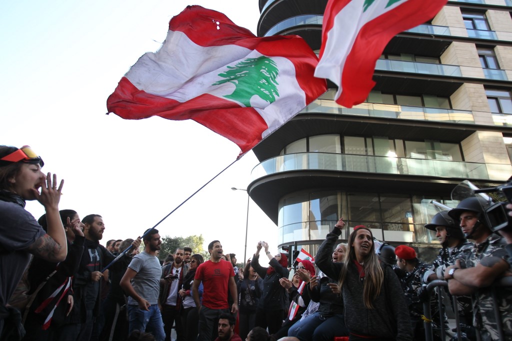 PROTEST. Lebanese anti-government protesters shout slogans in front of a barrier near parliament headquarters in the capital Beirut on November 19, 2019. Photo by Ibrahim Amro/AFP 