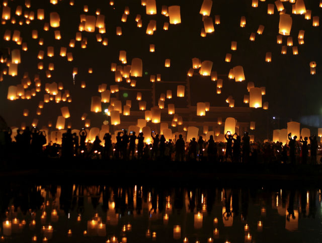 RELEASE TO THE SKY. A photo made available on 26 October 2014 shows Thais release thousands of hot air lanterns during the Yi Peng festival celebrations in Chiang Mai, northern Thailand, late 25 October 2014. The ancient northern traditional festival is held annually by launching floating lanterns into the night sky with the belief that misfortune will fly away with the lanterns as part of Loy Krathong celebrations. Photo by Pongmanat Tasiri/EPA 