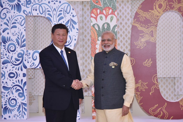 BRICS SUMMIT. In this photo released by the Indian Press Information Bureau on October 16, 2016, Indian Prime Minister Narendra Modi (R) shakes hands with Chinese President Xi Jinping at the BRICS Summit in Goa. Photo by PIB/AFP 