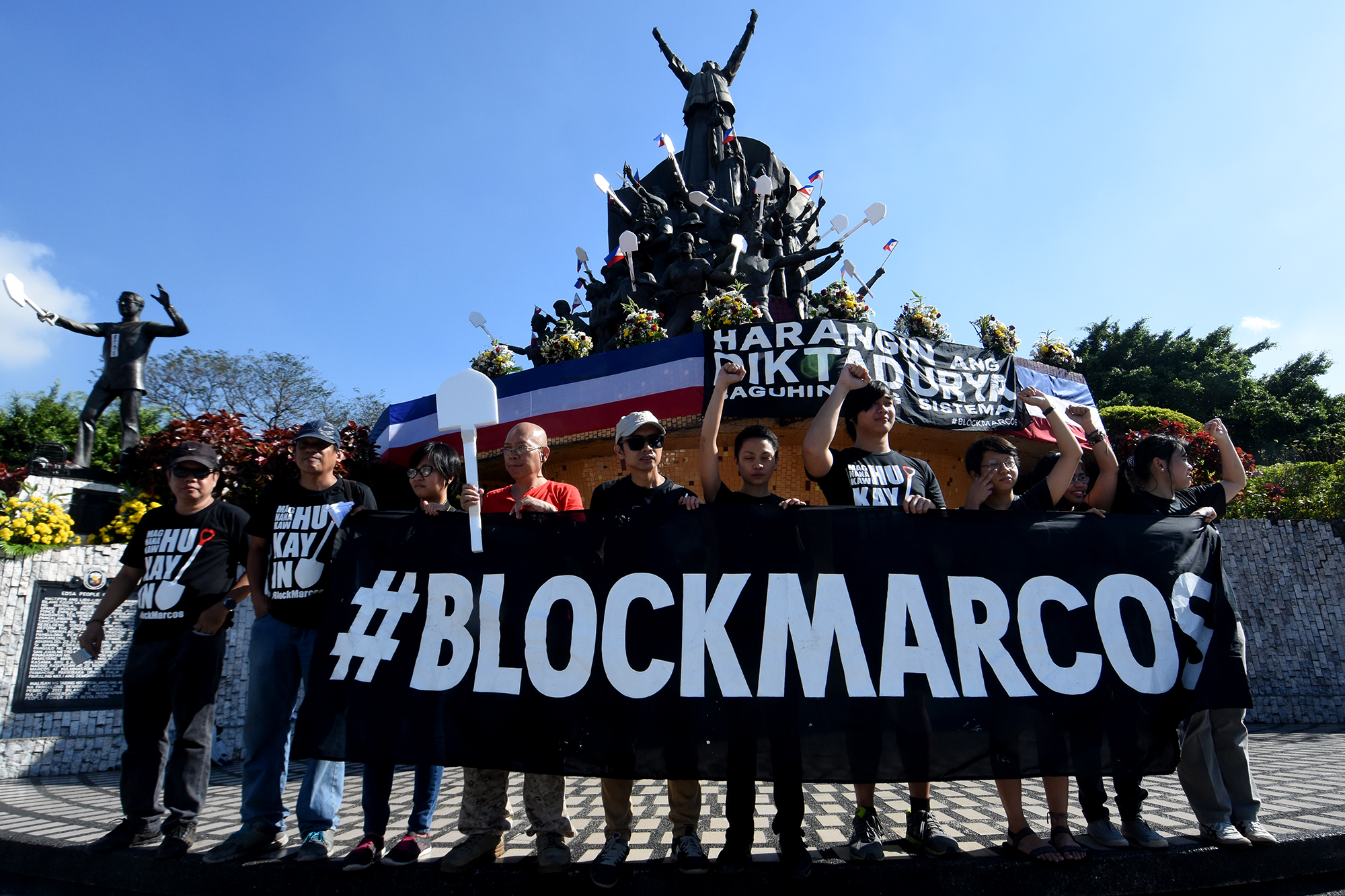 BLOCK MARCOS. Activists from the Block Marcos Movement lift their fists in front of the People Power Monument. Photo by Angie de Silva/Rappler 
