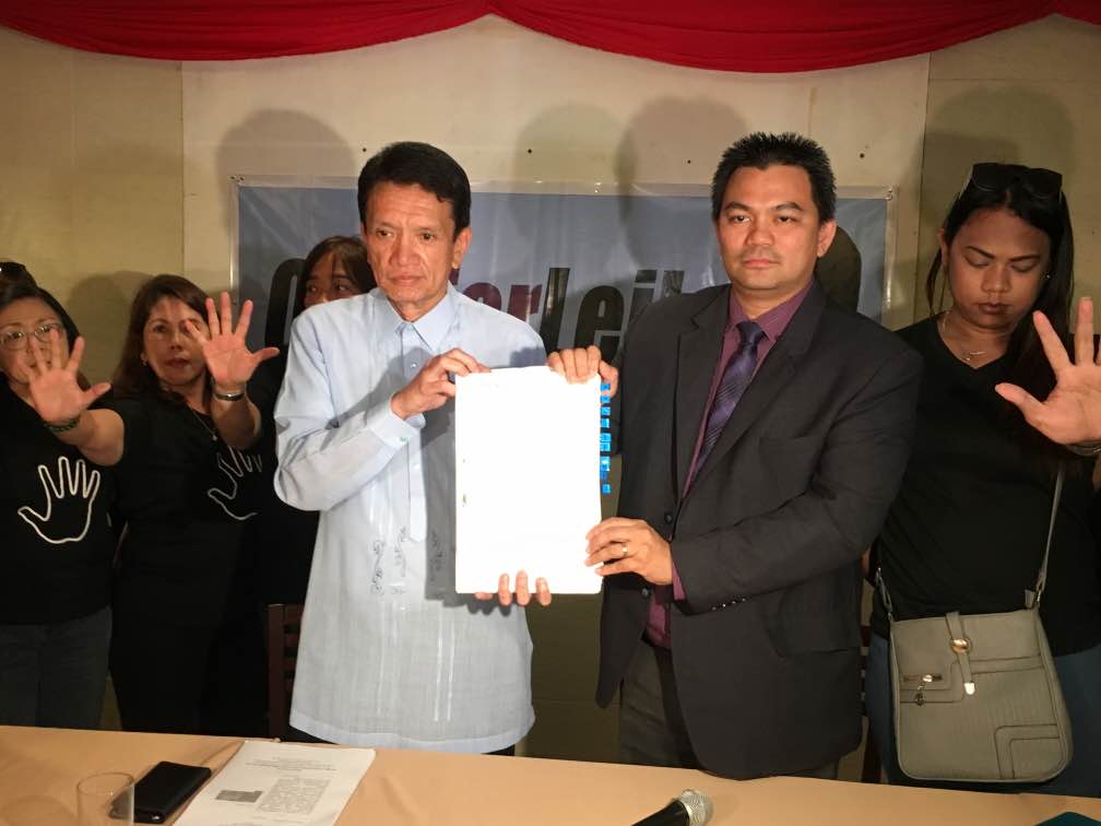 PETITION. Atty Alex Padilla (front L), lawyer of Senator Leila de Lima, and the senator's chief of staff Atty Philip Sawali, hold a copy of a petition to the Supreme Court seeking to halt the senator's arrest, February 27, 2017. Photo by Camille Elemia/Rappler   