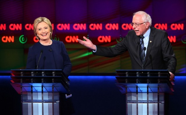 FACE OFF. Democratic presidential candidate Senator Bernie Sanders (D-VT) and Democratic presidential candidate Hillary Clinton speak during the CNN Democratic Presidential Primary Debate at the Whiting Auditorium at the Cultural Center Campus on March 6, 2016 in Flint, Michigan. Scott Olson/Getty Images/AFP