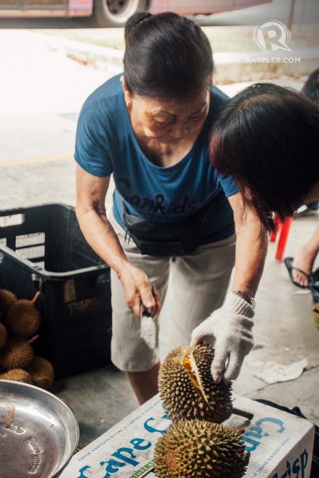 KING OF THE FRUITS. An "aunty,” who runs a fruit shop on Tiong Bahru Road, prepares a durian. Although found all over Southeast Asia, the spiky fruit has become a Singaporean icon on its own that inspires both reverence and loathing – for its taste and infamous smell. Even some local pastries and desserts are durian-flavored. 