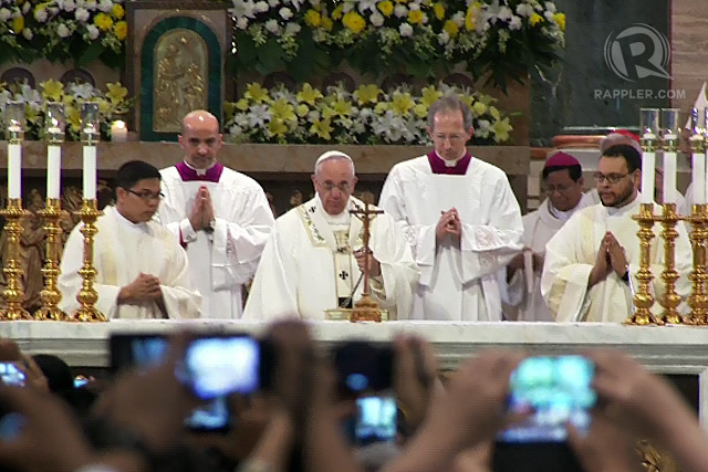 PHONES OUT. Priests take photos of Pope Francis as he celebrates Mass at the Manila Cathedral on January 16, 2015.