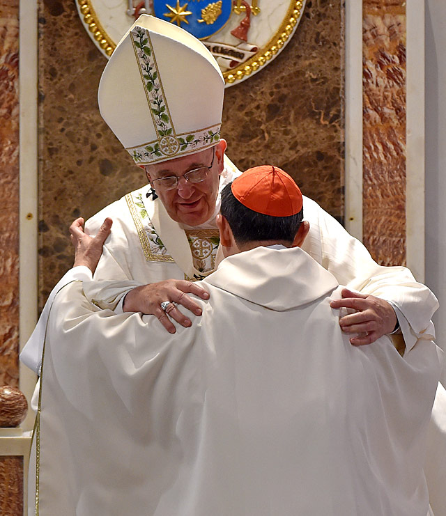 Pope Francis embraces Philippine Cardinal Luis Antonio Tagle as he leads a mass with bishops, priests and nuns in the Cathedral of the Immaculate Conception (Manila Cathedral) on January 16, 2015. Photo by Ettore Ferrari/EPA