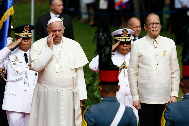 Pope Francis gestures as he stands next to President Benigno Aquino III during arrival honors at Malacanang Palace, Manila on January 16, 2015. Photo by Dennis Sabangan/EPA