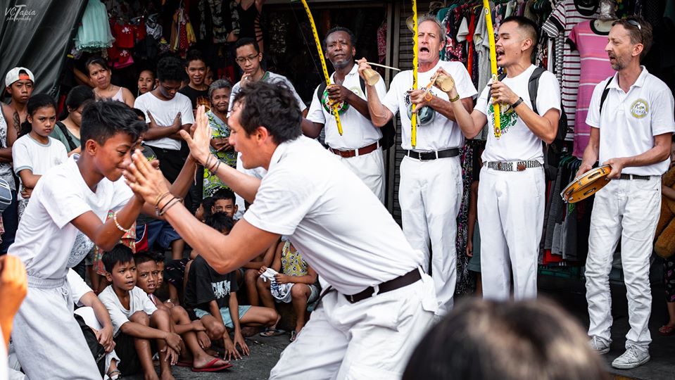 HOPE. Students and instructors play Capoeira Angola, with Mestre Roxinho (fourth from left) among the musicians in the background.
Photo by VCTapia Photography 