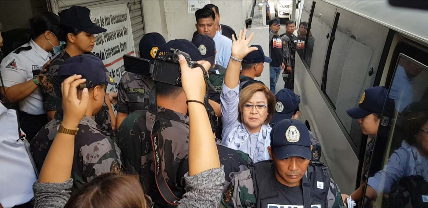FILE PHOTO. Opposition Senator Leila de Lima flashes her iconic D5 hand sign to greet onlookers and supporters as they crowded the side entrance of the Quezon City Hall of Justice chanting 'Free Leila!, Pekeng Ebidensya Ibasura!' expressing their  support to the detained senator. Photo from Senate PRIB  