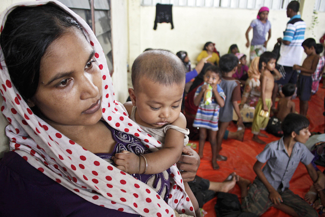 MOTHER AND CHILD. A mother and her baby inside the refugee camp at Kuala Langsa. Photo by EPA  