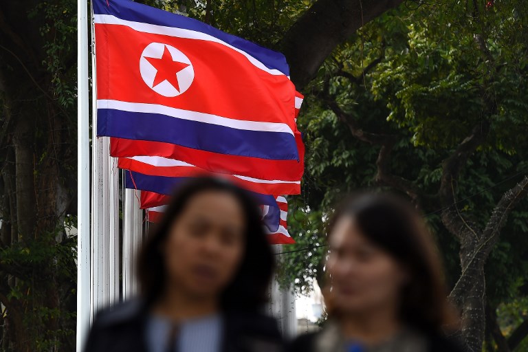 NUCLEAR NO-DEAL. Vietnamese women walk past North Korean flags on a street in Hanoi on March 1, 2019, a day after the second US-North Korea summit. Photo by Nhac Nguyen/AFP 
