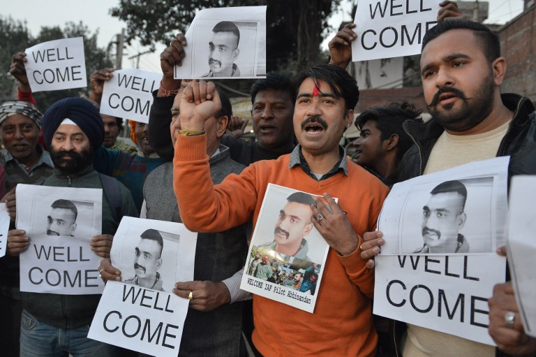 FREEING THE PILOT. Indian people hold placards and photographs of Indian Air Force pilot Abhinandan Varthaman, as they celebrate the announcement of his soon release, in Amritsar on February 28, 2019. Photo by Narinder Nanu/AFP 