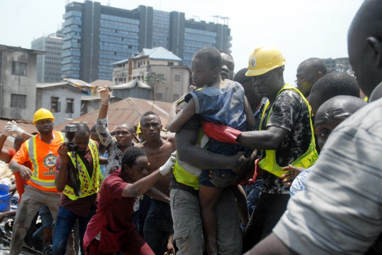 RESCUE. Emergency personnel rescue a child at the site of a building which collapsed in Lagos on March 13, 2019. File photo by Segun Ogunfeyitimi/AFP 