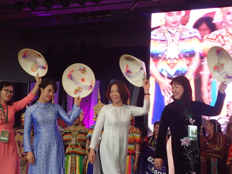 SIMPLE AND COLORFUL. Vietnamese walking in ao dai, their traditional attire. 