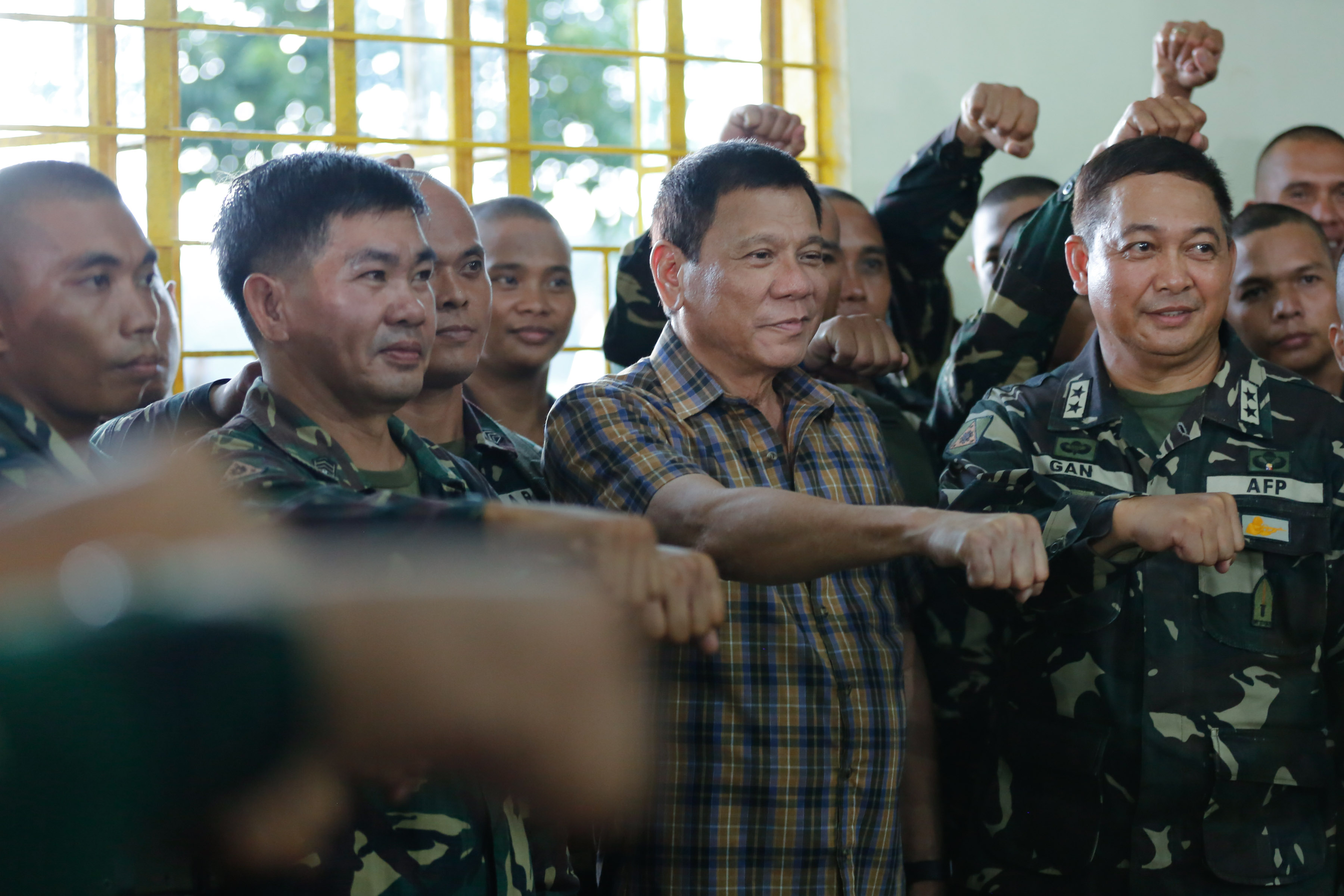 DUTERTE'S PROMISES. President Rodrigo Duterte does the fist gesture with uniformed personnel of the 2nd Infantry Division at Camp Capinpin in Tanay, Rizal on August 24, 2016. Photo by Toto Lozano/PPD  