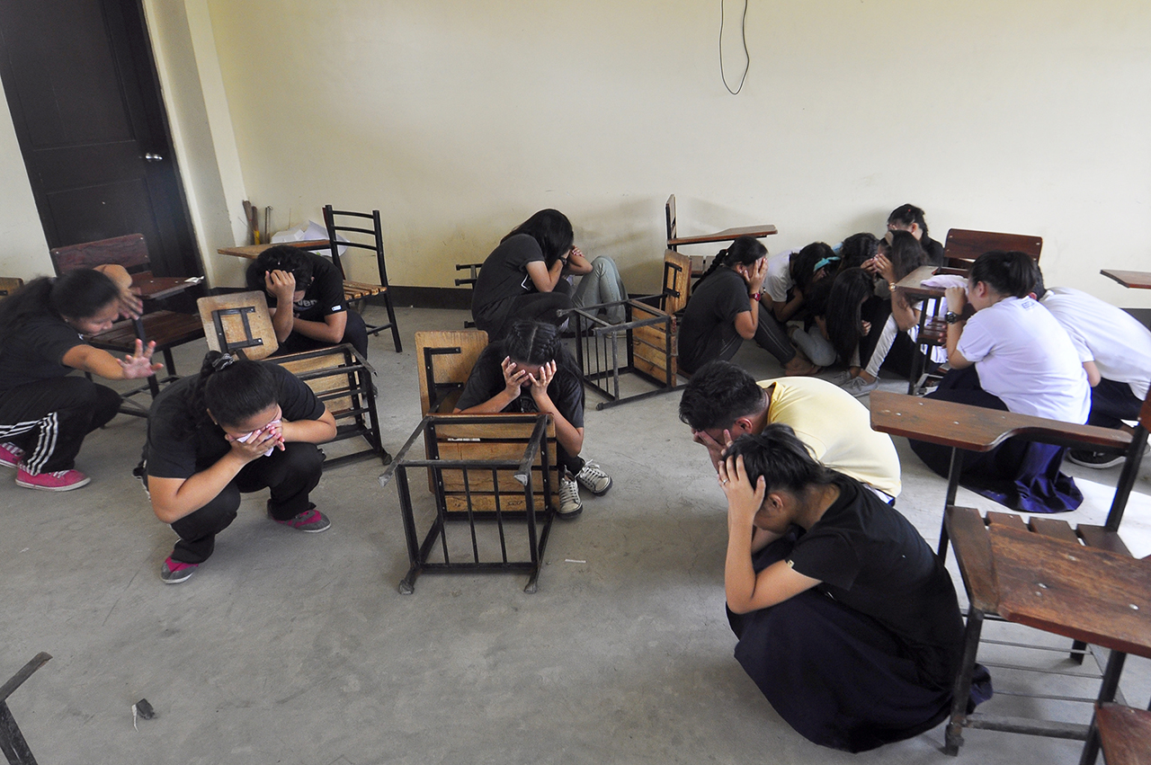 RESCUE. In this photo, students take cover as 'terrorists' attack the building. Photo by Angie De Silva/Rappler