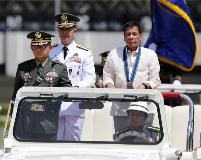 PARADE AND REVIEW. President Rodrigo Duterte reviews honor guards during the change of command ceremony in Camp Aguinaldo. Acting AFP chief Lt General Glorioso Miranda relinquished his position to new AFP chief Lt General Ricardo Visaya (center). Photo by Francis Malasig/EPA  