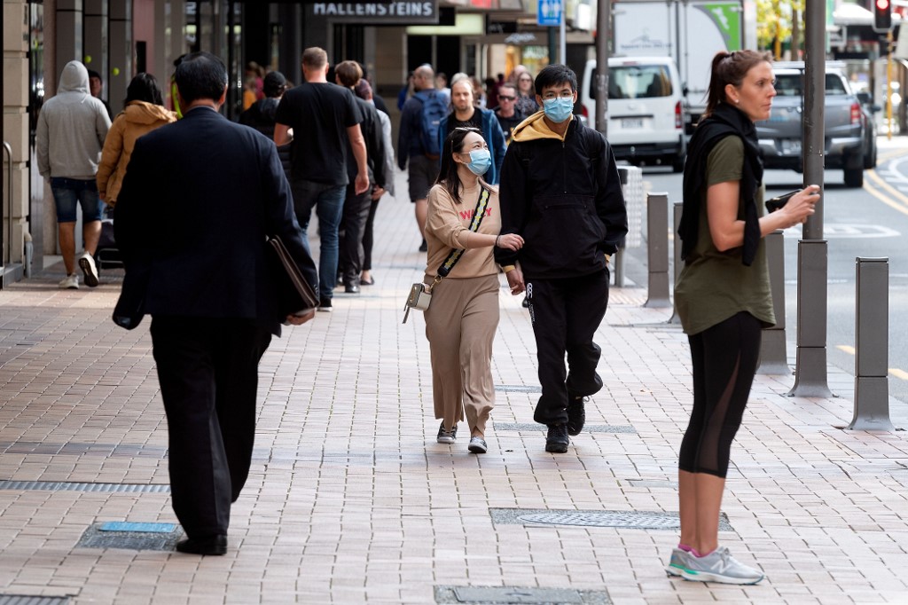 STROLL. People walk on a street in Wellington on May 14, 2020. Photo by Marty Melville/AFP 