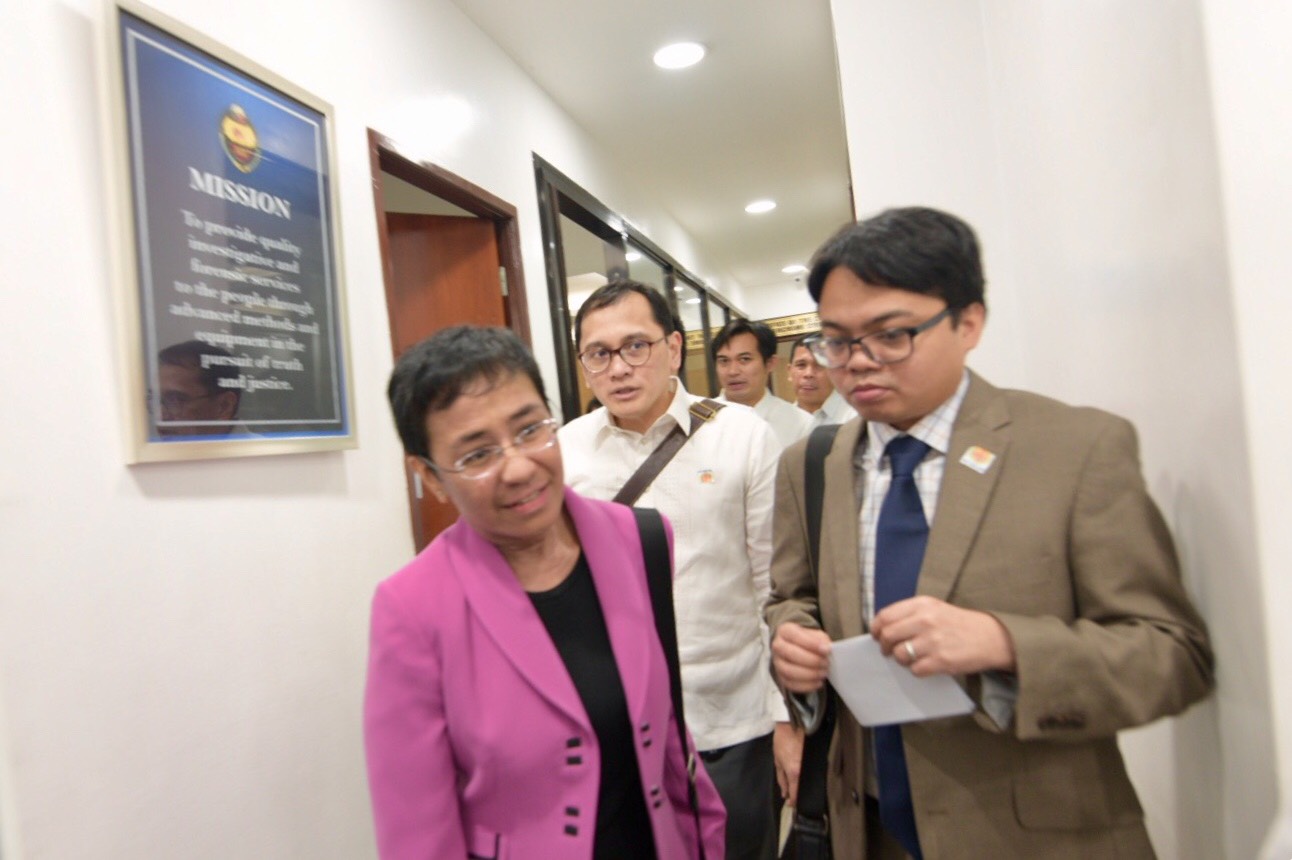 CYBER LIBEL. Maria Ressa and lawyer JJ Disini (in white, behind Ressa) appear at the NBI Cybercrime Division after receiving a subpoena for a cyber libel complaint.
Photo by Leanne Jazul/Rappler 