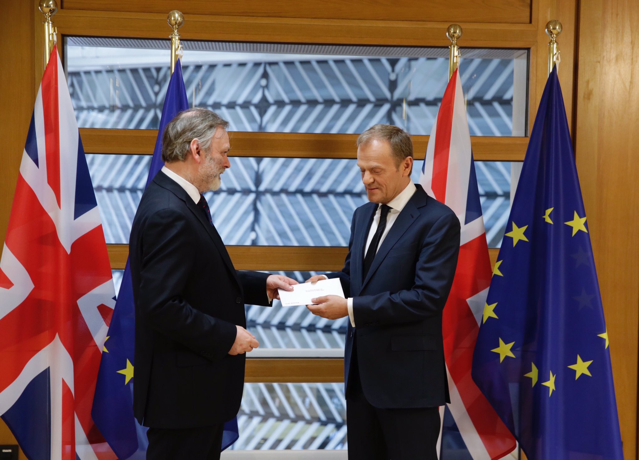 TRIGGERING BREXIT. Tim Barrow, UK Permanent Representative to the European Union, hands a letter to EU president Donald Tusk formally notifying the bloc of the United Kingdom's intention to leave the group, at the EU headquarters in Brussels, Belgium, March 29, 2017. Photo courtesy @eucopresident / Twitter 