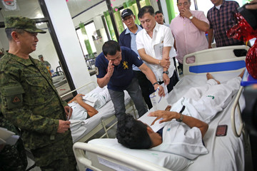 SALUTE. President Rodrigo Roa Duterte salutes one of the soldiers wounded in recent military encounters with the Abu Sayyaf Group (ASG) in Basilan, as he visits Camp Navarro General Hospital in Zamboanga City on December 17, 2016. Photo by Robinson Ninal Jr/Presidential Photo 