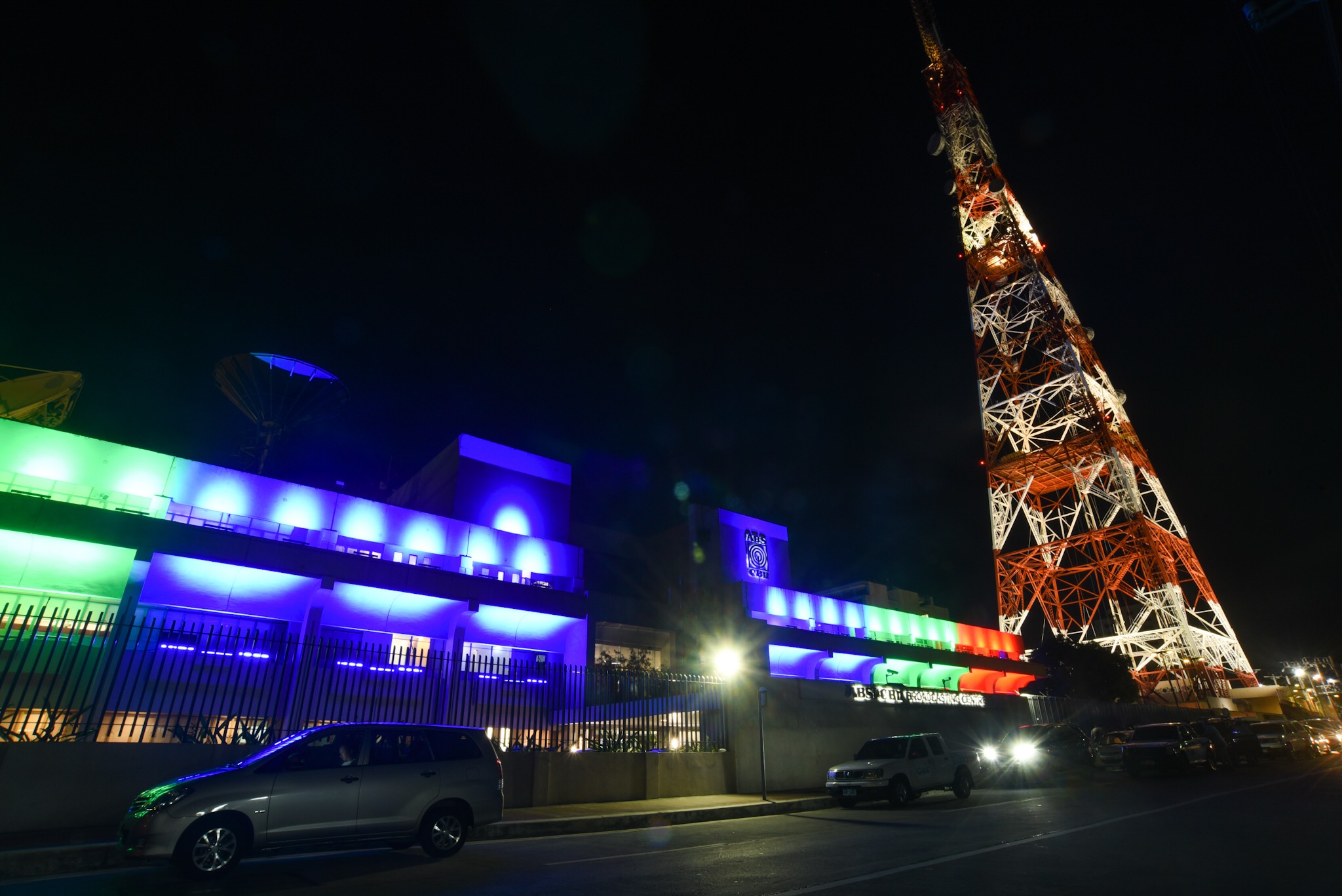 SHUTDOWN. The facade of ABS-CBN lights up in the network's color after the NTC issued a cease and desist order against it on May 5, 2020. File photo by Angie de Silva/Rappler 