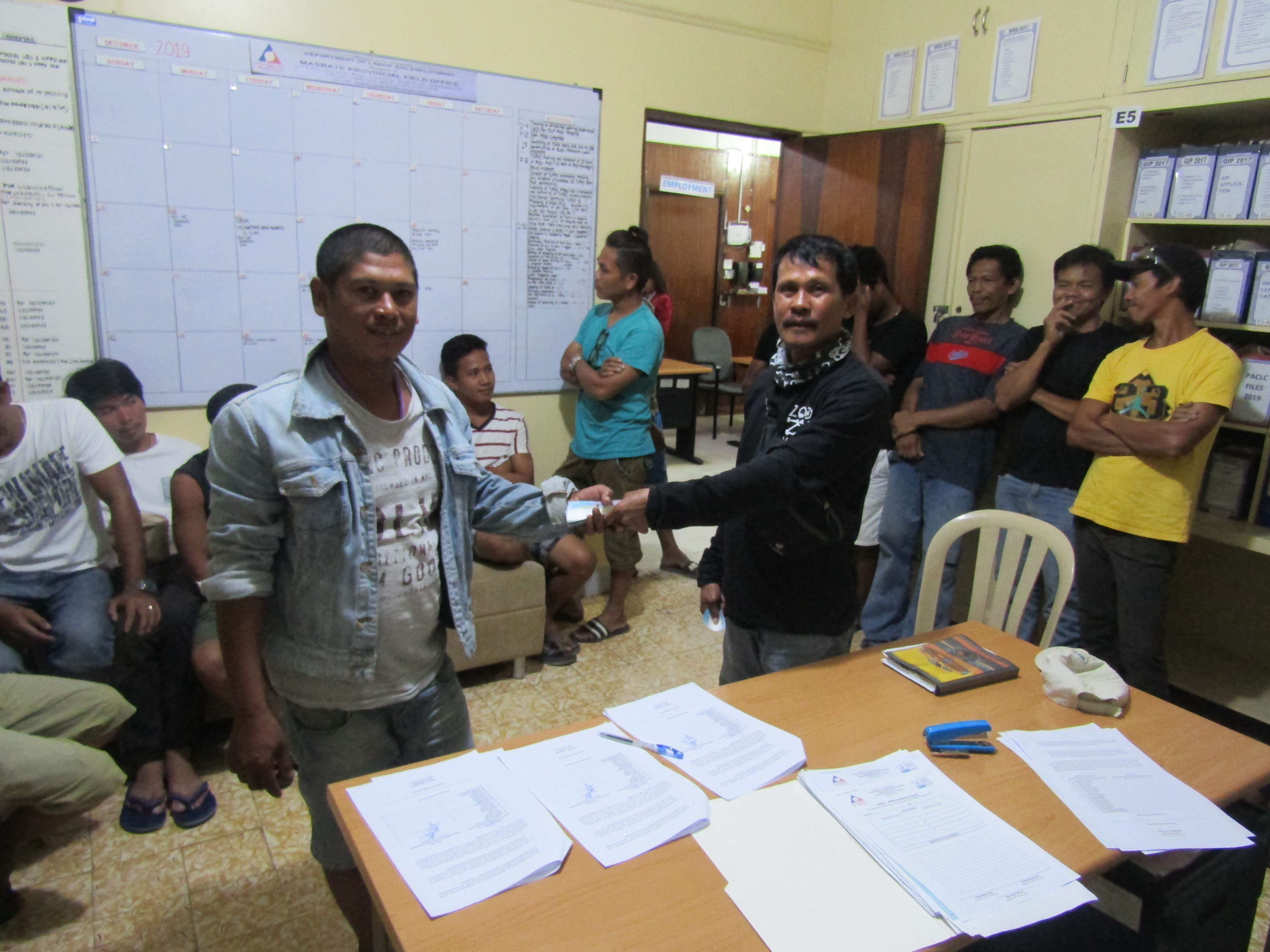 SETTLED. One of the displaced workers in Masbate that received his separation pay together with SEADO Masbate Chito Atibagos. Photo courtesy of DOLE Masbate.  