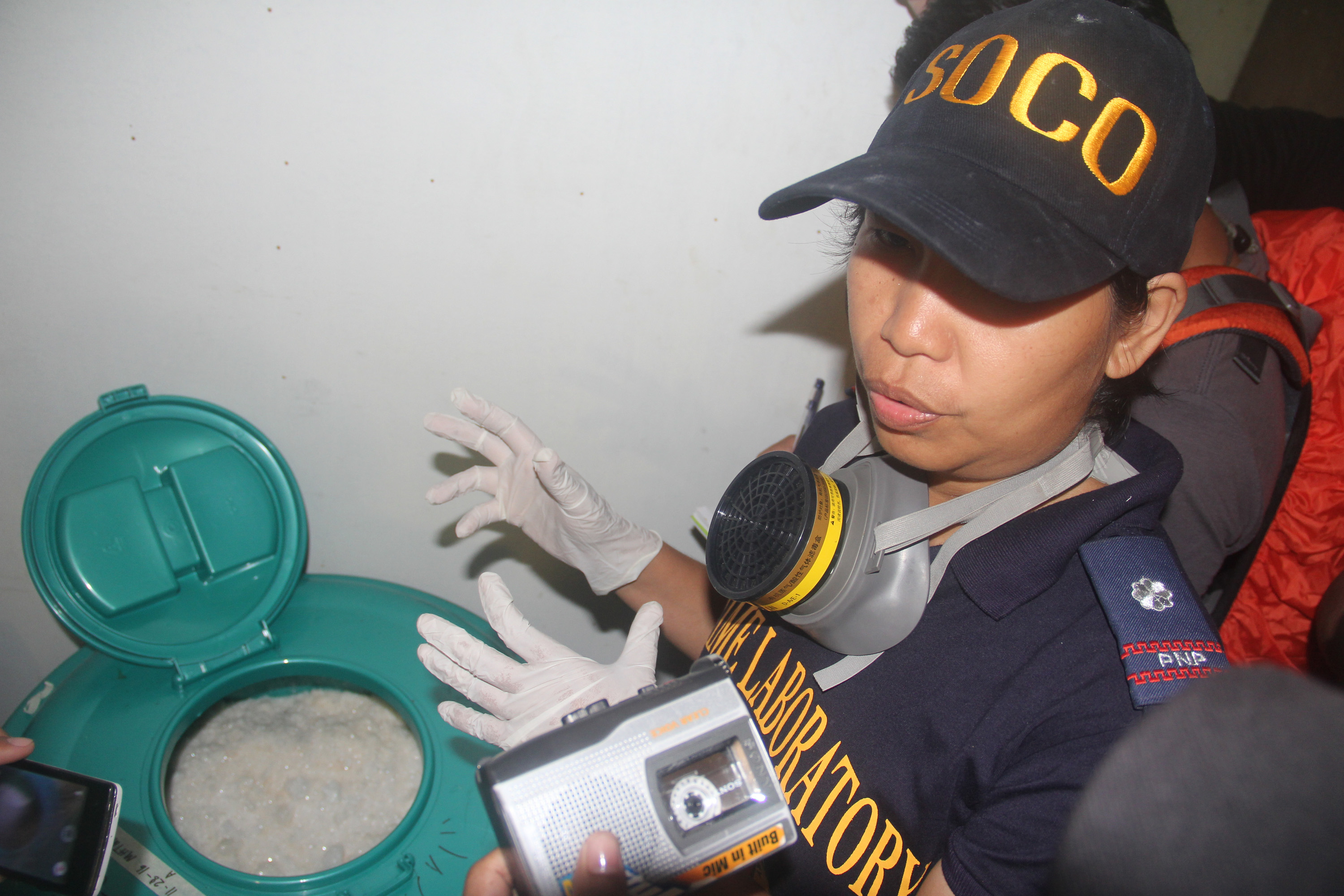 SHABU-MAKING MATERIALS. Forensic official Josephine Clemen of PNP Crime Lab shows off several drums of ephedrine hydrochloride used for shabu manufacturing discovered anew during the investigation. Photo by Rhaydz B. Barcia/Rappler  