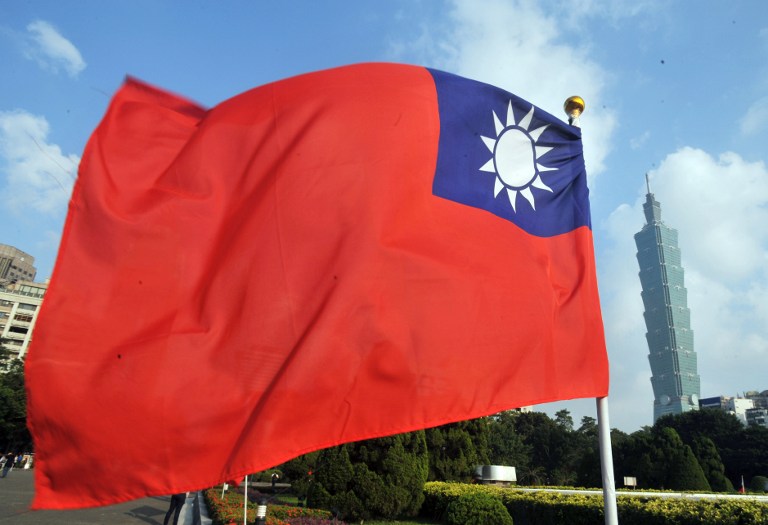 VISIT TAIWAN. Taiwan's national flag flutters beside Taipei 101 at Sun Yat-sen Memorial Hall in Taipei on October 7, 2012. Photo by Mandy Cheng/AFP 