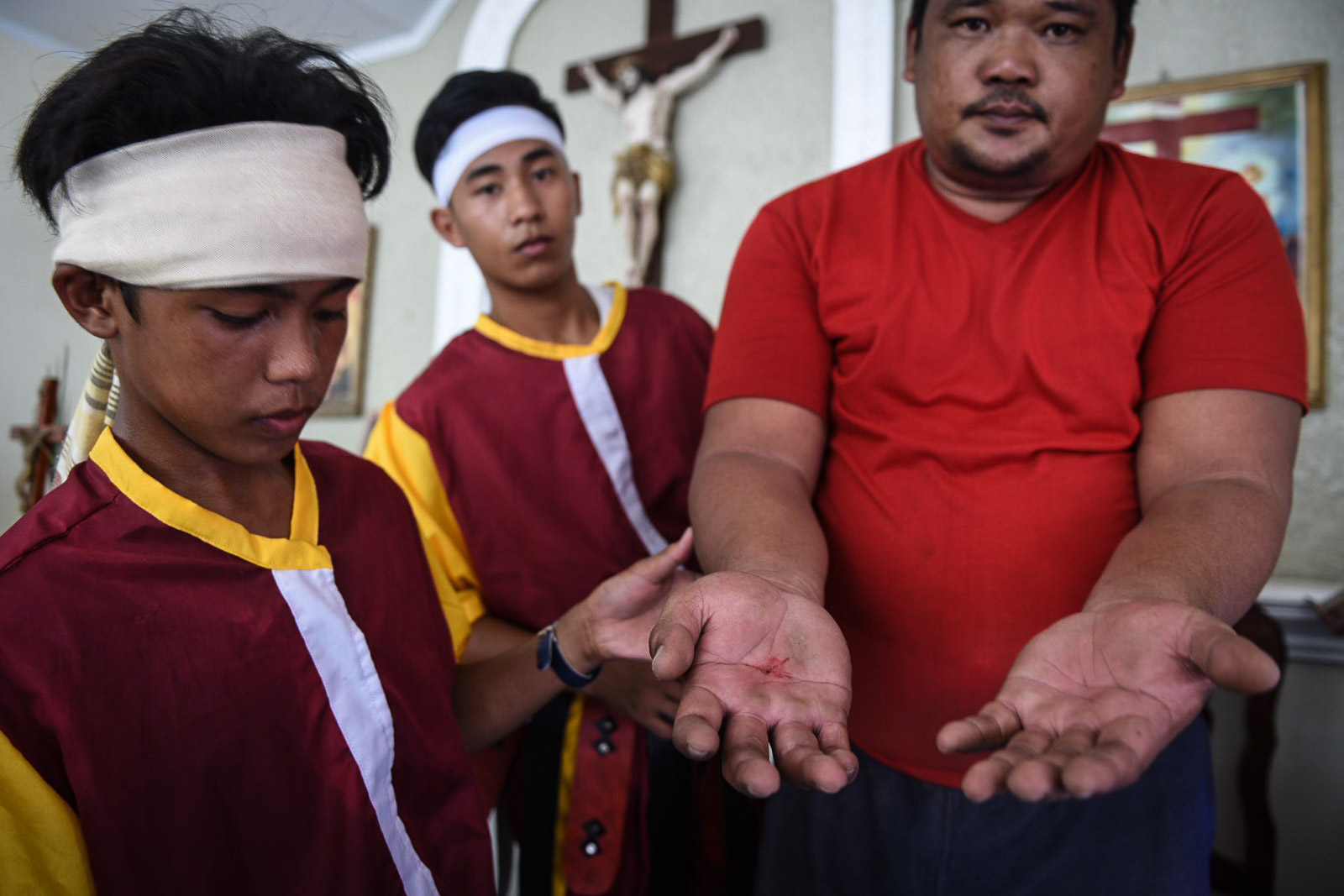 THE WOUND. Marcelino shows his hands to the crowd after the Passion play. 