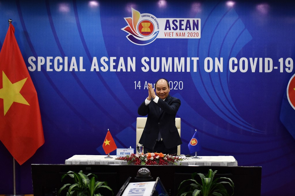 TALKING ONLINE. Vietnam's Prime Minister Nguyen Xuan Phuc greets other member country leaders during a live video conference on the special Association of Southeast Asian Nations (ASEAN) Summit on the COVID-19 coronavirus pandemic in Hanoi on April 14, 2020. Photo by Manan Vatsyayana/AFP 