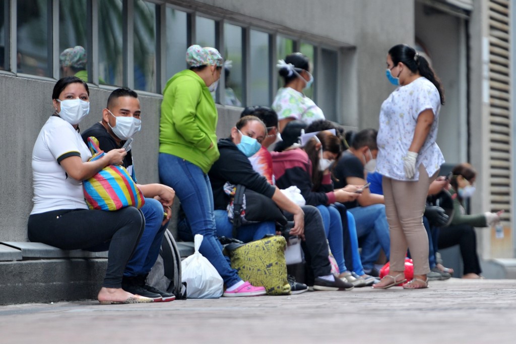 TESTING. People wear face masks as they wait outside the Omnihospital to be tested for the coronavirus in Guayaquil, Ecuador, on April 28, 2020. Photo by Jose Sanchez Lindao/AFP 