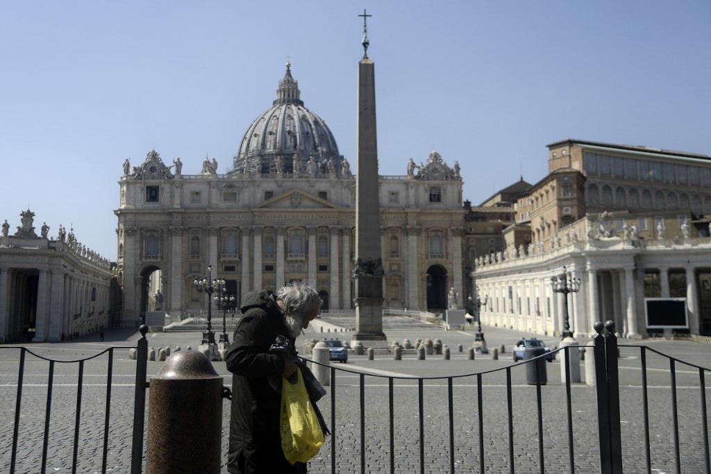 LOCKDOWN. An elderly homeless man stands by a barrier closing access to the Vatican's St Peter's Square on April 10, 2020, during the lockdown in Italy. Photo by Filippo Monteforte/AFP 
