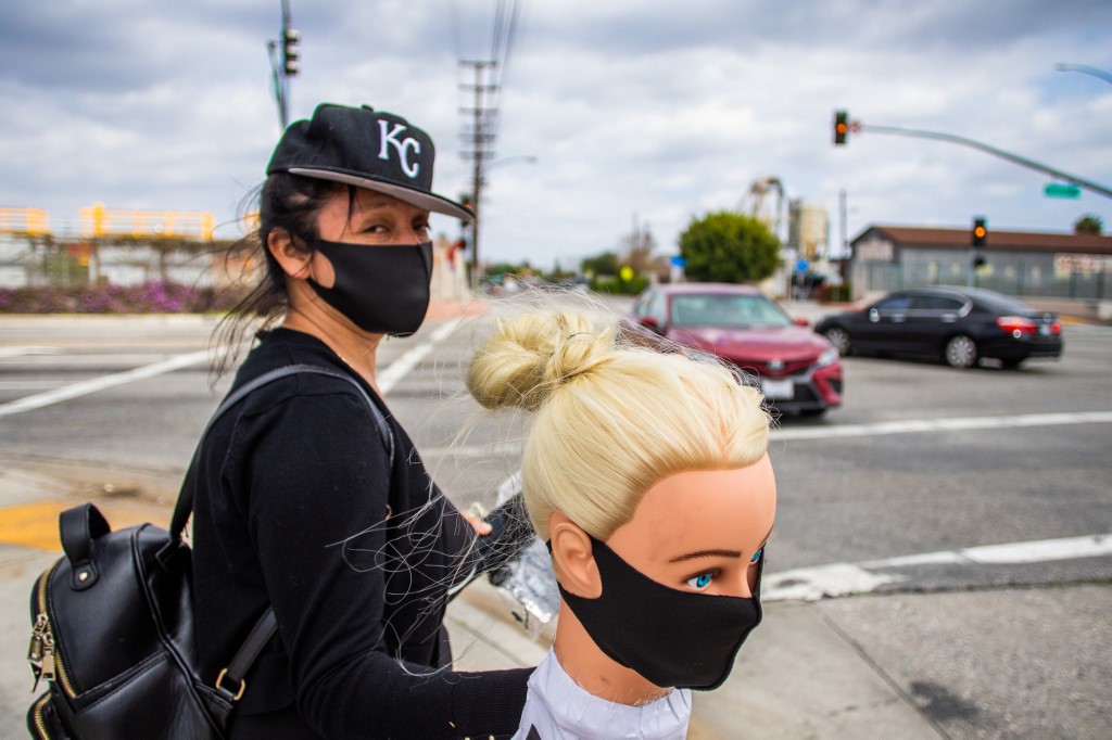 SELLING. Dressmaker Flor Hernandez sells face masks in Los Angeles, California, after losing her job during the coronavirus outbreak. Photo by Apu Gomes/AFP 