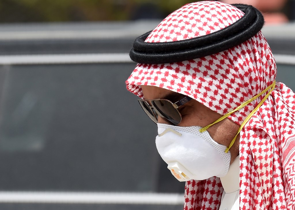 PROTECTIVE GEAR. A Saudi man, wearing a face mask as a precaution against the coronavirus, walks along Tahlia Street in the center of the capital Riyadh on March 15, 2020. Photo by Fayez Nureldine/AFP 