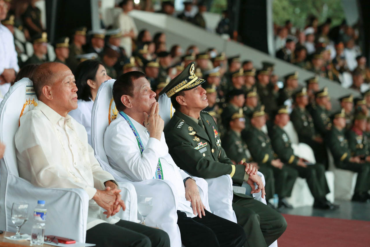 LOOK UP. Defense Secretary Delfin Lorenzana, President Rodrigo Duterte, and General Noel Clement watch a drone show during the Armed Forces of the Philippines' 84th founding anniversary ceremony on December 17, 2019. Photo by Richard Madelo/Presidential photo 