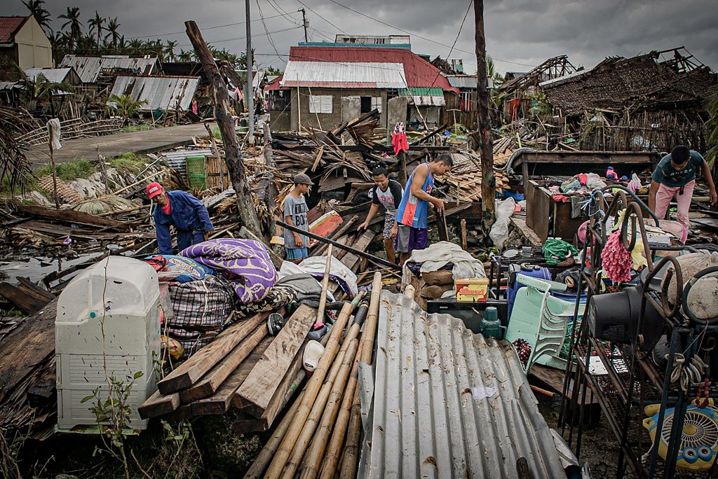 AFTERMATH. Residents try to salvage belongings amongst their houses destroyed at the height of Typhoon Vongfong in San Policarpo town, Eastern Samar province on May 15, 2020, a day after the typhoon hit the town. Photo by Alren Beronio/AFP 