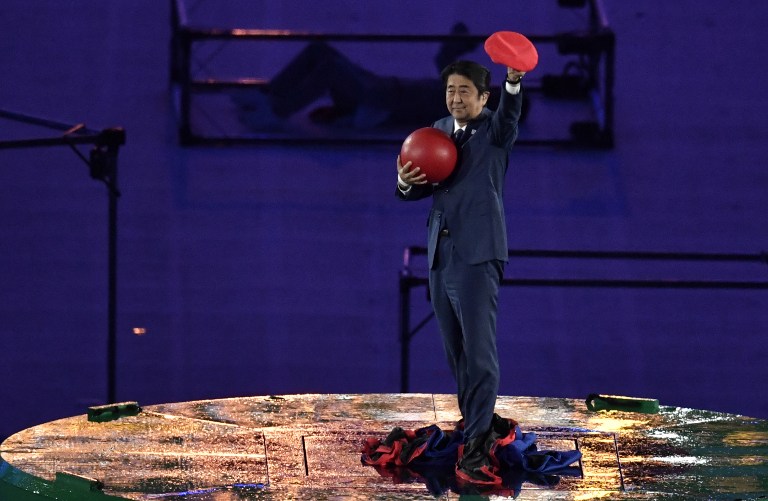 SUPER MARIO. Japanese Prime Minister Shinzo Abe holds a red ball during the closing ceremony of the Rio 2016 Olympic Games at the Maracana stadium in Rio de Janeiro on August 21, 2016. Photo by Philippe Lopez/AFP  