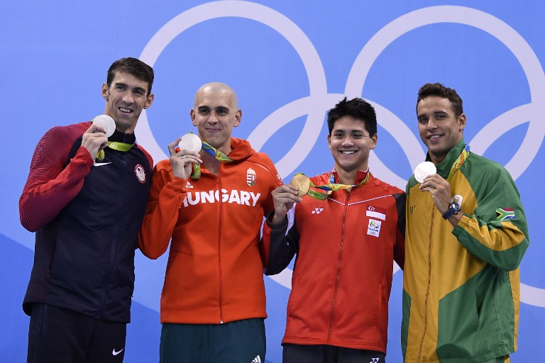 WINNERS. Singapore's Schooling Joseph (2ndR) poses with silver medallists (fromL) USA's Michael Phelps, Hungary's Laszlo Cseh and South Africa's Chad Guy Bertrand Le Clos after he won the Men's 100m Butterfly Final during the swimming event at the Rio 2016 Olympic Games at the Olympic Aquatics Stadium in Rio de Janeiro on August 12, 2016. Gabriel Bouys/AFP 