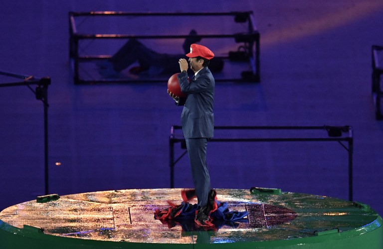 SURPRISE! Japanese Prime Minister Shinzo Abe, dressed as Super Mario, holds a red ball during the closing ceremony of the Rio 2016 Olympic Games at the Maracana stadium in Rio de Janeiro on August 21, 2016. Photo by Philippe Lopez/AFP  