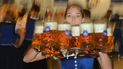 BALANCING ACT. A waitress carries beer mugs in a festival tent after the start of the Oktoberfest beer festival. Photo by AFP.