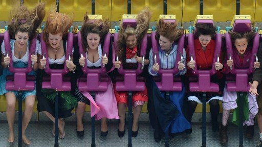 WILD SWINGS. Visitors wearing traditional Bavarian ride a fairground ride at the Oktoberfest beer festival at the Theresienwiese in Munich, southern Germany. Photo by AFP
